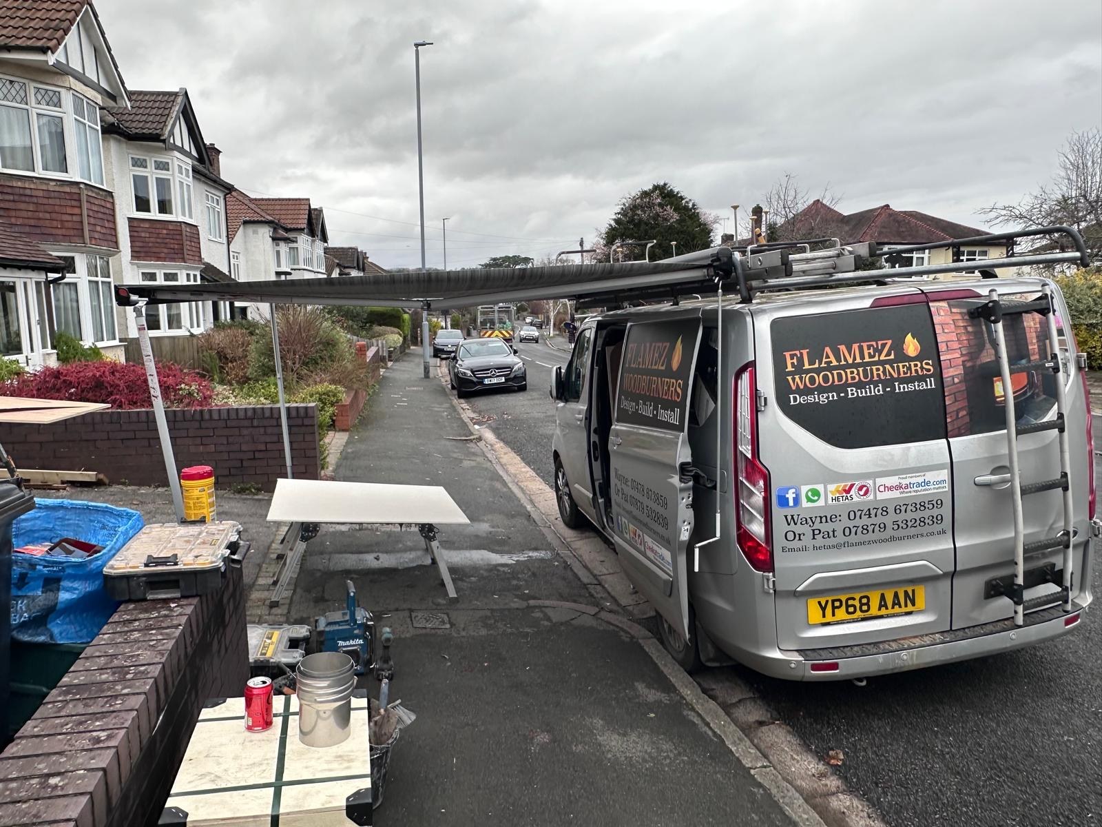 Flamez Woodburners van parked up on a job with tools set out on the pavement