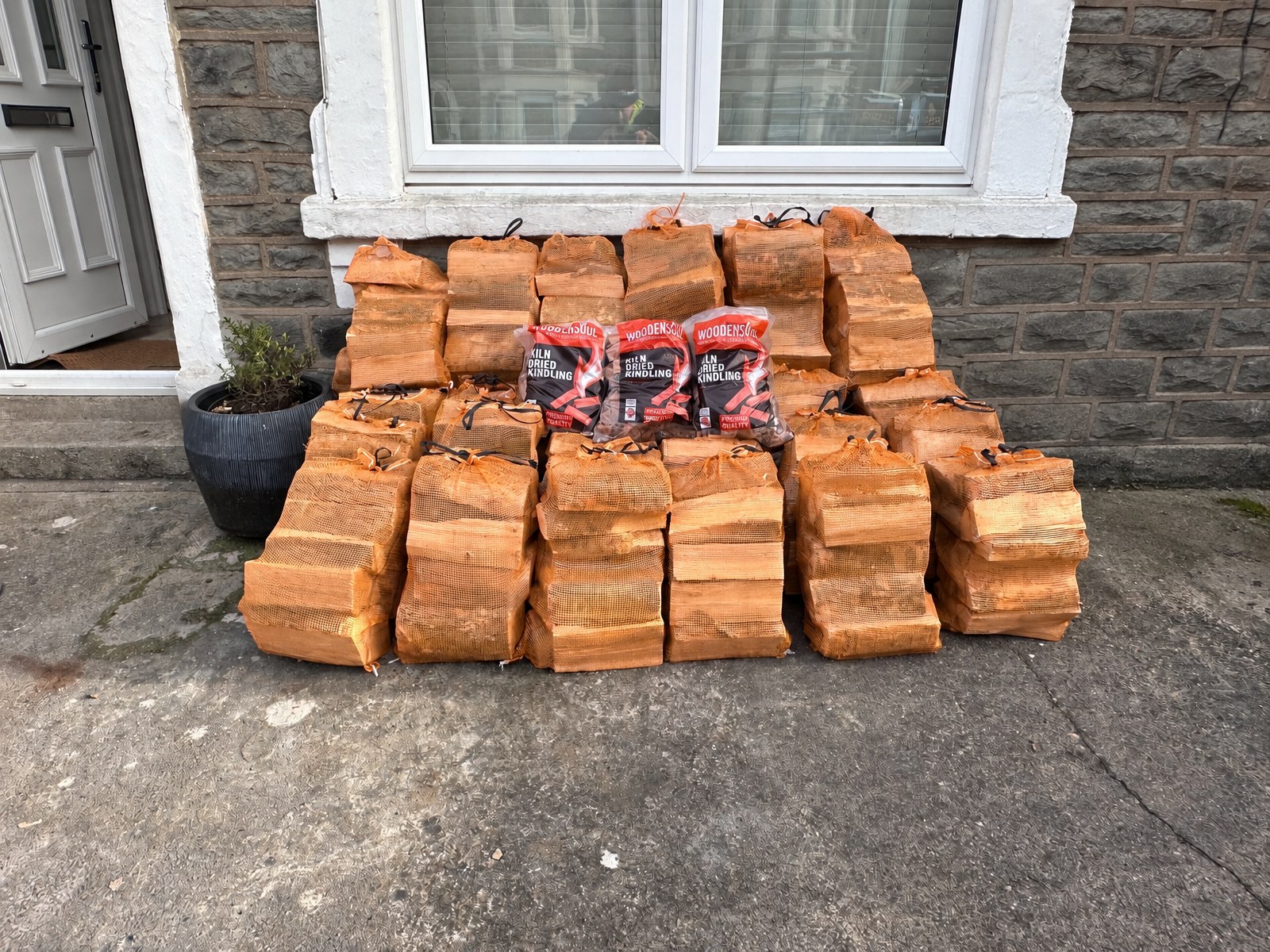 Bags of kiln-dried logs and kindling delivered to a customer's front door