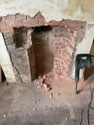 Fireplace opened back to brick, ready for a new liner and stove