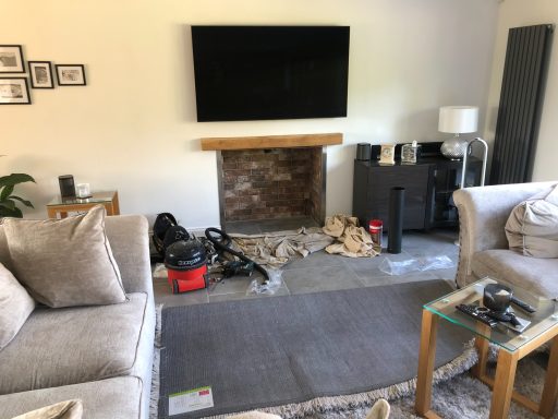 Living room protected with dust sheets partway through an installation
